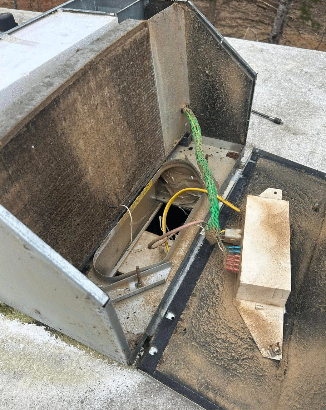 Dirty rooftop RV AC unit opened for cleaning and repair inspection